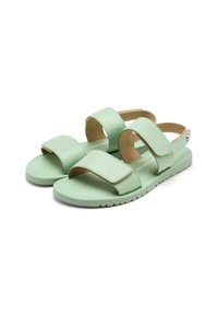Sandalias verde menta con dos correas ajustables, suela plana y plantilla acolchada. Fabricadas con material sintético suave. Diseño ligero.