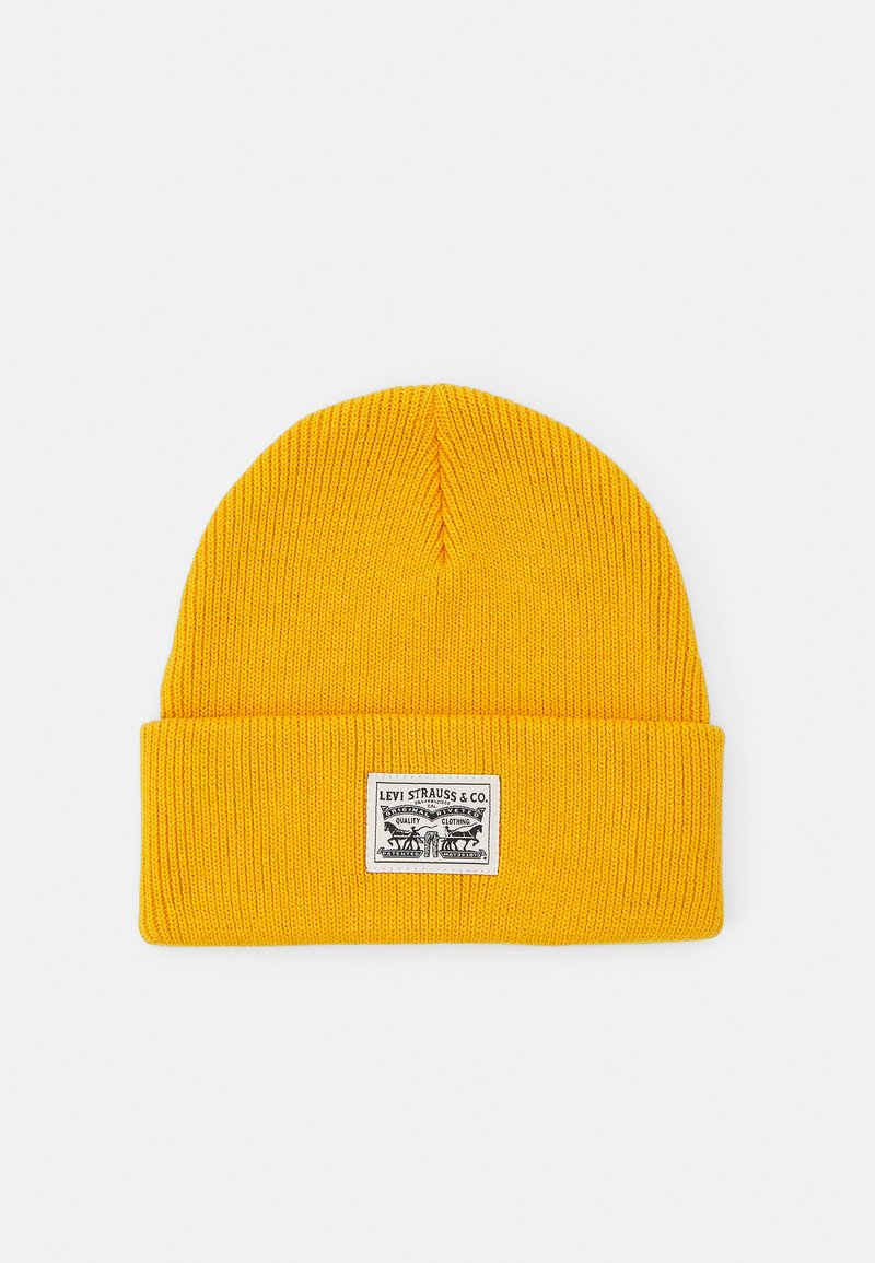 Yellow knit beanie with a folded brim, featuring a rectangular Levi Strauss & Co. label at the front. Texture is ribbed and smooth.