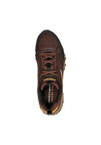 Brown athletic shoe with a mesh and synthetic upper, black and orange accents, rubber outsole, and molded heel. Features "Memory Foam" label.