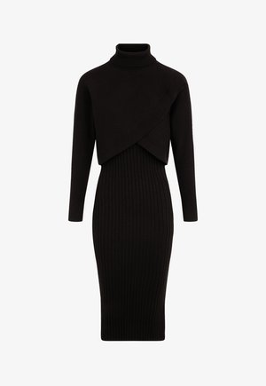 Abito a coste nere con collo alto, maniche lunghe e un design asimmetrico con top corto. Silhouette aderente.