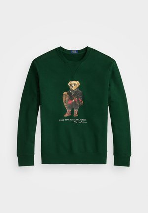 Green cotton sweatshirt featuring a bear in a blazer and sunglasses, holding snowshoes, with "Polo Bear by Ralph Lauren" text below.
