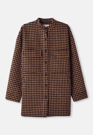 Brown and black houndstooth patterned shirt jacket with a mandarin collar, front button closure, and two chest pockets.
