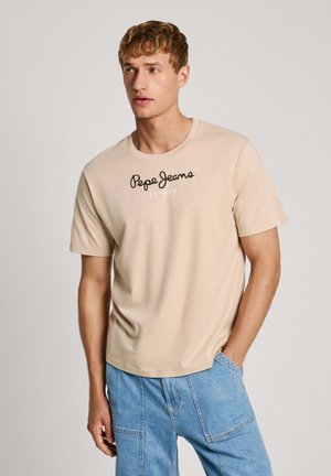 T-shirt beige a maniche corte in cotone con scollo rotondo, caratterizzata da un logo nero "Pepe Jeans London" sul petto.