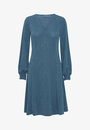 En knälång klänning i djup teal med långa ärmar och volangade manschetter, V-ringning och ett strukturerat, glittrande tyg.