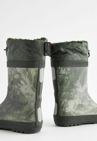 Grüne wasserdichte Stiefel mit einem gesteppten Oberteil, strukturiertem Gummifuß und abstrakten, dunkelgrünen Mustern; verfügen über eine Zuglasche und verstärkte Seiten.