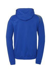 Blauwe capuchonjack van gladde stof, voorzien van een driehoekig patroon in het geel op de schouder. Elastische zoom en manchetten.