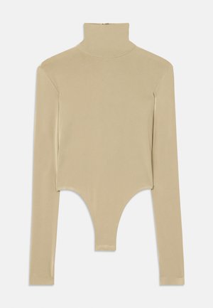 Beige long-sleeve turtleneck top made of smooth fabric, featuring a cut-out bottom with a fitted shape and minimalistic design.