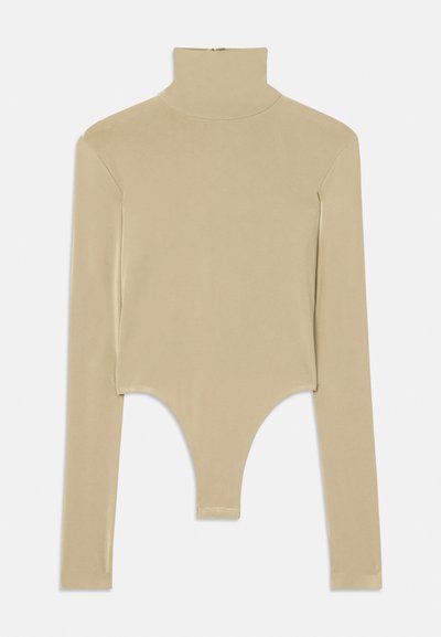 Beige long-sleeve turtleneck top made of smooth fabric, featuring a cut-out bottom with a fitted shape and minimalistic design.