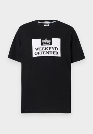 T-shirt noir à manches courtes avec un graphique rectangulaire blanc arborant une icône de couronne et le texte "WEEKEND OFFENDER" en lettres majuscules et en gras.