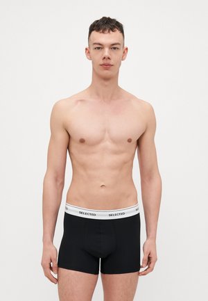 Sorte boxershorts med en hvid elastisk talje, der har ordet "SELECTED" trykt omkring sig. Glat tekstur, tætsiddende design.