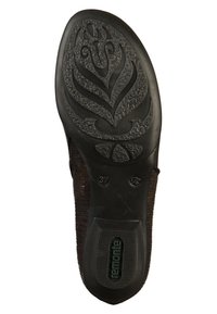 Suola di scarpa in gomma nera con intricati motivi floreali, superficie testurizzata e dettaglio del marchio. Forma leggermente sagomata per il comfort.