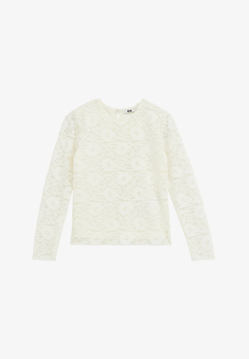 Blouse en dentelle blanche à manches longues avec motif floral et col rond, présentée à plat sur un fond blanc.