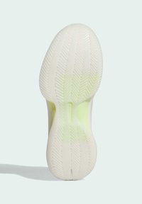 Sole of white athletic shoe with herringbone tread pattern and light green accents on a pale gray background.