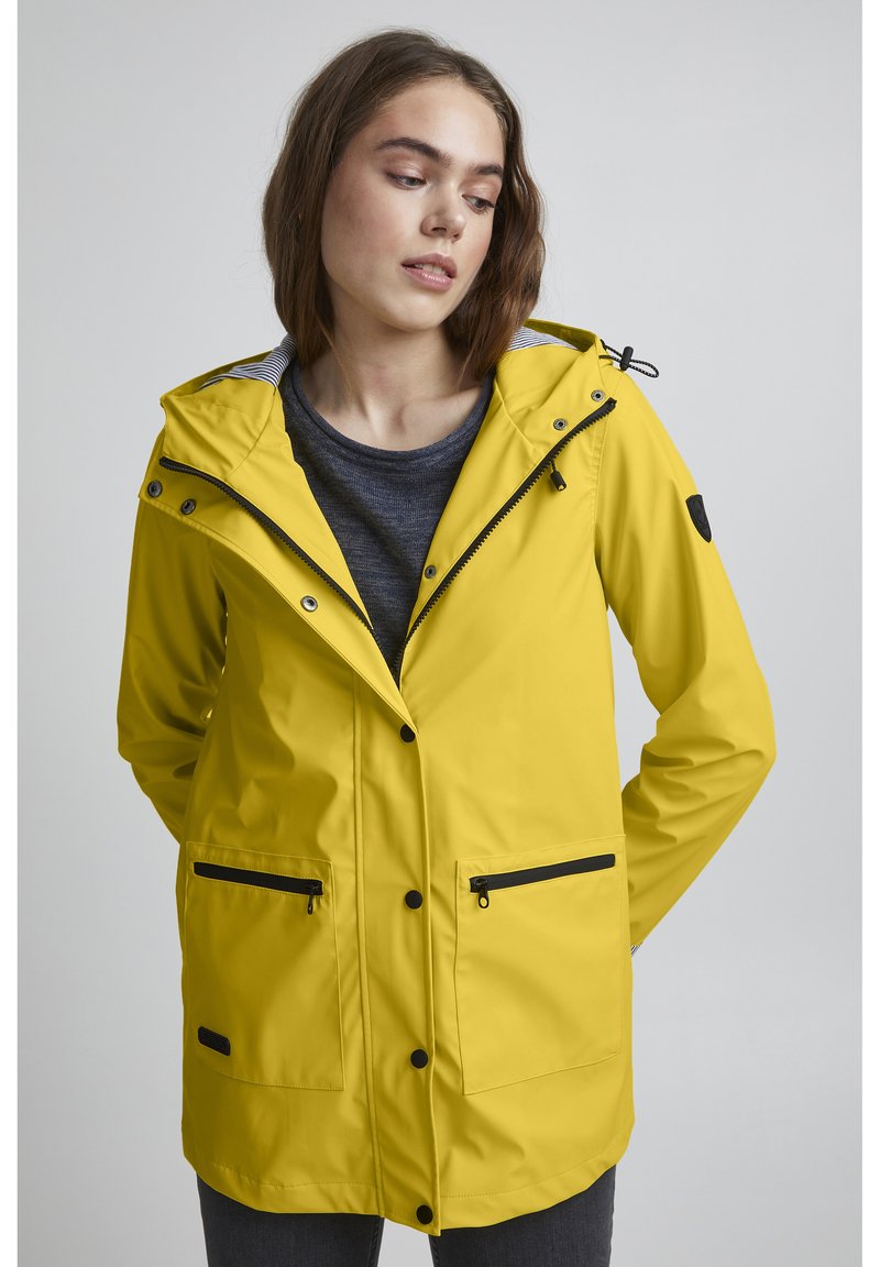 Yellow waterproof jacket with a hood, featuring a zip and button closure, two front pockets, and black accents. The interior has a striped pattern.