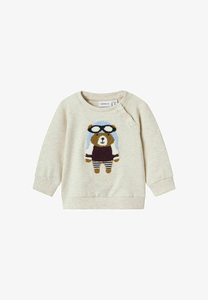 Light beige sweatshirt with a bear pilot design, featuring a blue cap and glasses. Ribbed cuffs and bottom hem, textured embroidery detail.