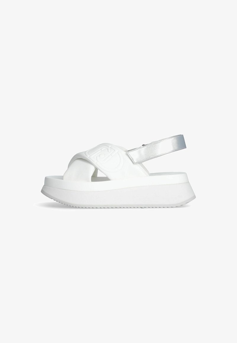 Weiße Plateausandalen mit einer strukturierten Gummisohle, breiten oberen Riemen und einem metallic-silbernen Akzent am verstellbaren Fersenriemen.