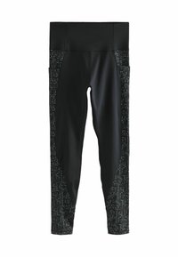 Leggings noirs avec une taille haute, texture lisse et un panneau latéral présentant un motif à pois en matériau contrasté.