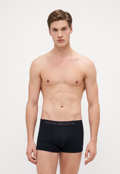 Black cotton boxer briefs with a logoed waistband, fitted design, and smooth texture. No additional patterns or hardware details visible.
