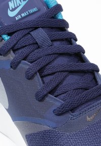 Nike Air Max Tavas-sneakers i marinblått och teal; har överdel i texturerat mesh, tjocka snören och en slät, kontrasterande grå accent.