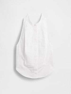 Λευκή αμάνικη μπλούζα με γιακά μανδαρινιού, με κάθετες πιέτες στο μπροστινό μέρος και στρογγυλεμένο στρίφωμα στο κάτω μέρος. Λείο ύφασμα.