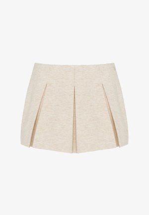 Mini-jupe plissée beige avec une coupe structurée, ajustée et une texture subtile, présentée sur fond blanc.