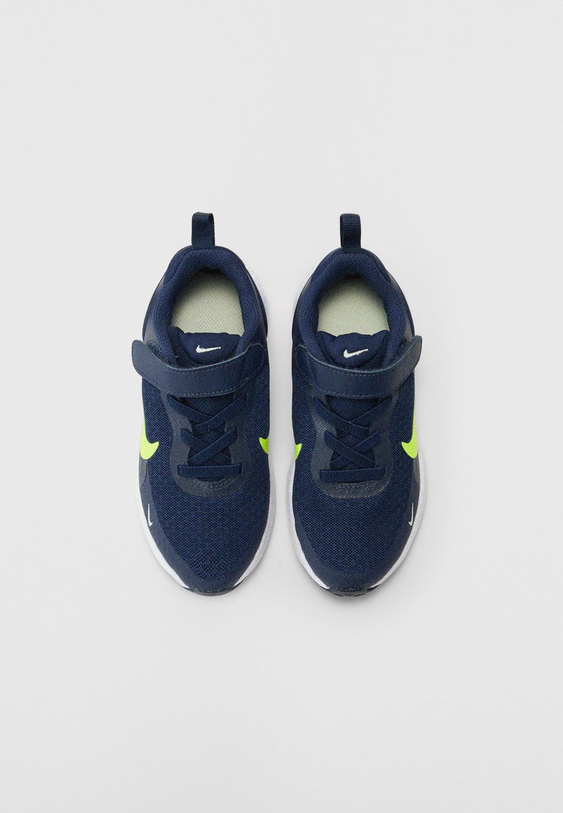 Marinefarbene Netzsportschuhe mit neon-gelben Akzenten, einem Klettverschluss und einer weißen Sohle. Verfügt über einen gepolsterten Kragen für zusätzlichen Komfort.