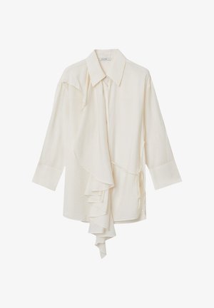 Blusa di un avorio chiaro con colletto appuntito, maniche lunghe, dettaglio anteriore arricciato, texture di tessuto morbido e nodo laterale per una vestibilità regolabile.