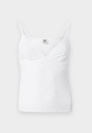 White cami top featuring a V-neck, thin adjustable straps, and delicate floral embroidery throughout the fabric. Smooth, lightweight texture.