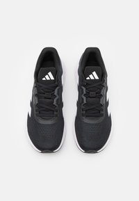 Black athletic shoes with a breathable mesh upper, white accents, and a textured sole. Features a lace-up design and cushioned ankle area.