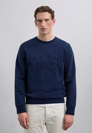 Navy sweatshirt with a textured logo featuring a skull and crossbones. Crew neckline, ribbed cuffs, and soft, smooth fabric.
