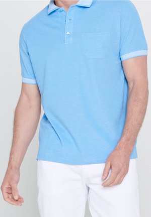 Hellblaues Polohemd aus weichem Stoff, mit einer Knopfleiste, Kragen und einer Brusttasche. Weiße Akzente an den Ärmeln.