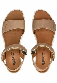 Brown leather sandals with a smooth texture, adjustable straps, and a cushioned tan insole. Features a white rubber sole and brand logo.