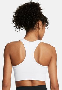 Under Armour VANISH SEAMLESS MID - Medium support sports bra - white