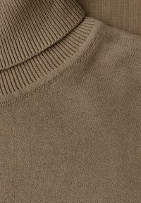Maglione marrone lavorato a maglia con colletto alto a coste, texture morbida e finitura liscia. Ingrandimento mostra i dettagli delle cuciture e il motivo del tessuto.