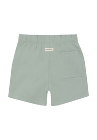 Ljust gröna bomullsshorts med elastisk midja, ett bakfack och sydda sömmar. Minimalistisk design och mjuk textur.