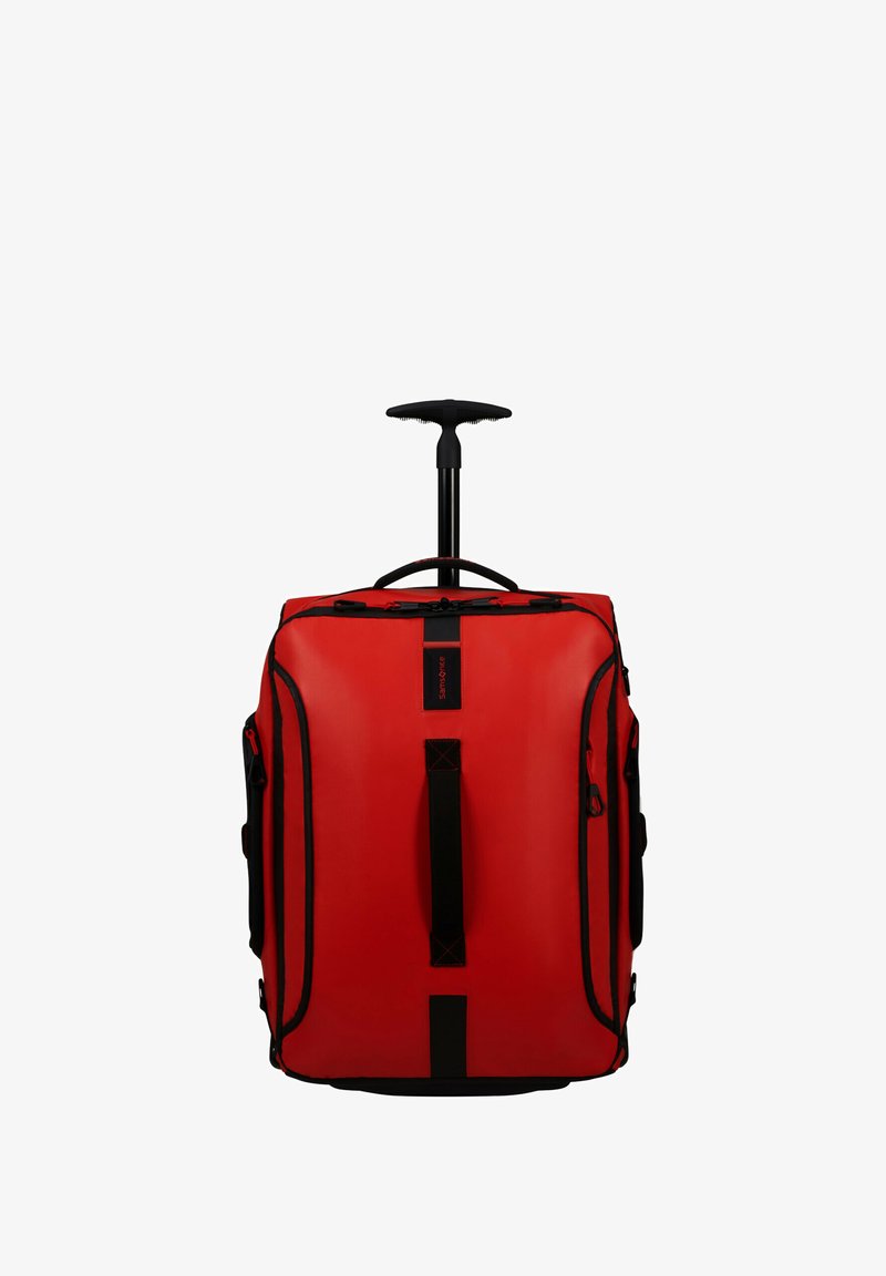Red wheeled duffel bag with a telescopic handle, black accents, sturdy grip handles, and multiple zippered pockets. Made of durable material.
