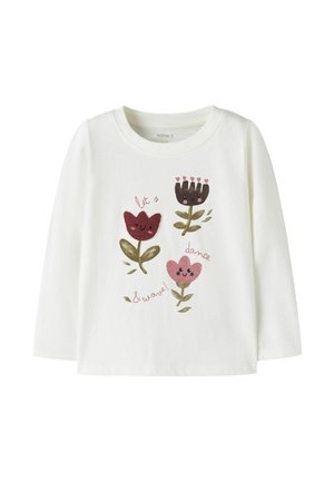 T-shirt blanc à manches longues pour tout-petits avec trois fleurs cartoon souriantes et le texte "let's dance & wave!" en tons roses et bruns.