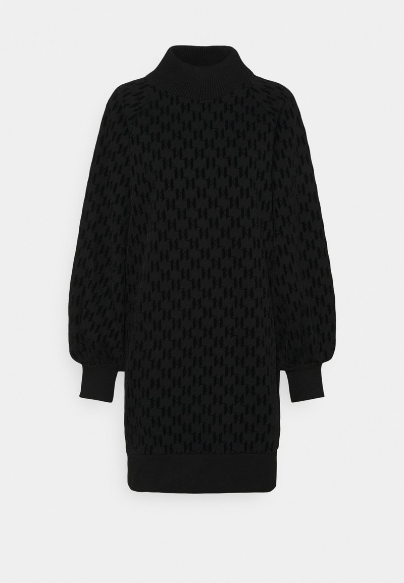 Svart stickad klänning med hög krage, strukturerat mönster, ballongärmar och ribbade muddar och kant.