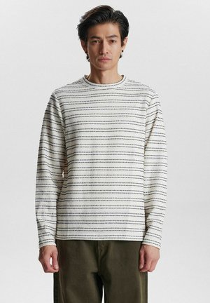 Langärmliges, Rundhals-Shirt in Creme mit horizontalen schwarzen Streifen. Verfügt über eine lockere Passform und einen weichen, strukturierten Stoff.