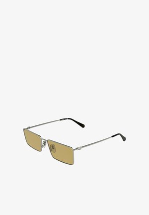 Occhiali da sole rettangolari sottili con montatura in metallo argento, lenti marroni sfumate e terminali delle aste neri, inclinati su uno sfondo bianco.