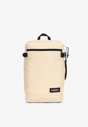 Beigenvärinen Eastpak-reppu suorakaiteen muotoinen, musta vetoketju, etutasku ja teksturoidusta kankaasta. Varustettu yläkahvalla ja sivulenkillä.