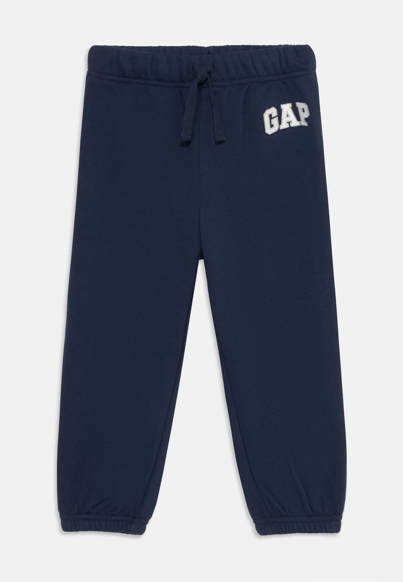 Marinblåa sweatpants med elastisk midja, snörning och elastiska avslut. Har broderad "GAP"-logga på framsidan. Mjuk tyg.