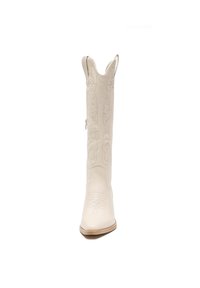 Bota de cowboy de cuero blanco con intrincados bordados florales, punta afilada y costuras sutiles. Detalle de cremallera lateral para facilitar su uso.