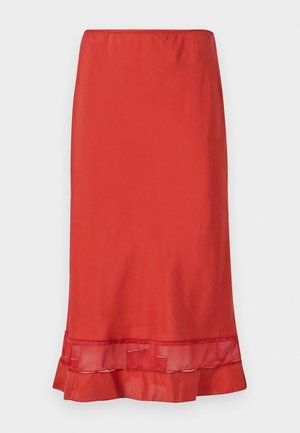 Red pencil skirt made of smooth fabric, featuring a mesh accent at the hem. Skirt has a fitted silhouette with a ruffled lower edge.