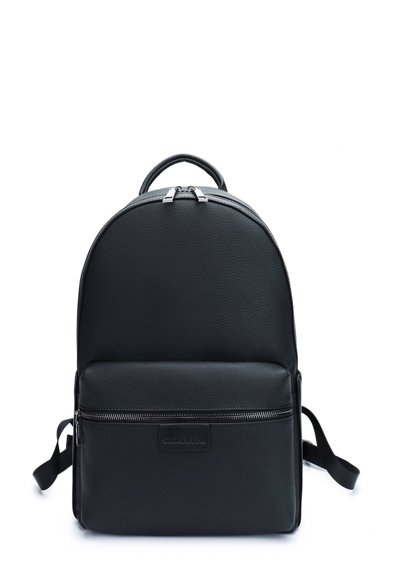 Black leather backpack with a rounded top, a front zip pocket, and adjustable straps. Features textured surface and metallic zipper accents.