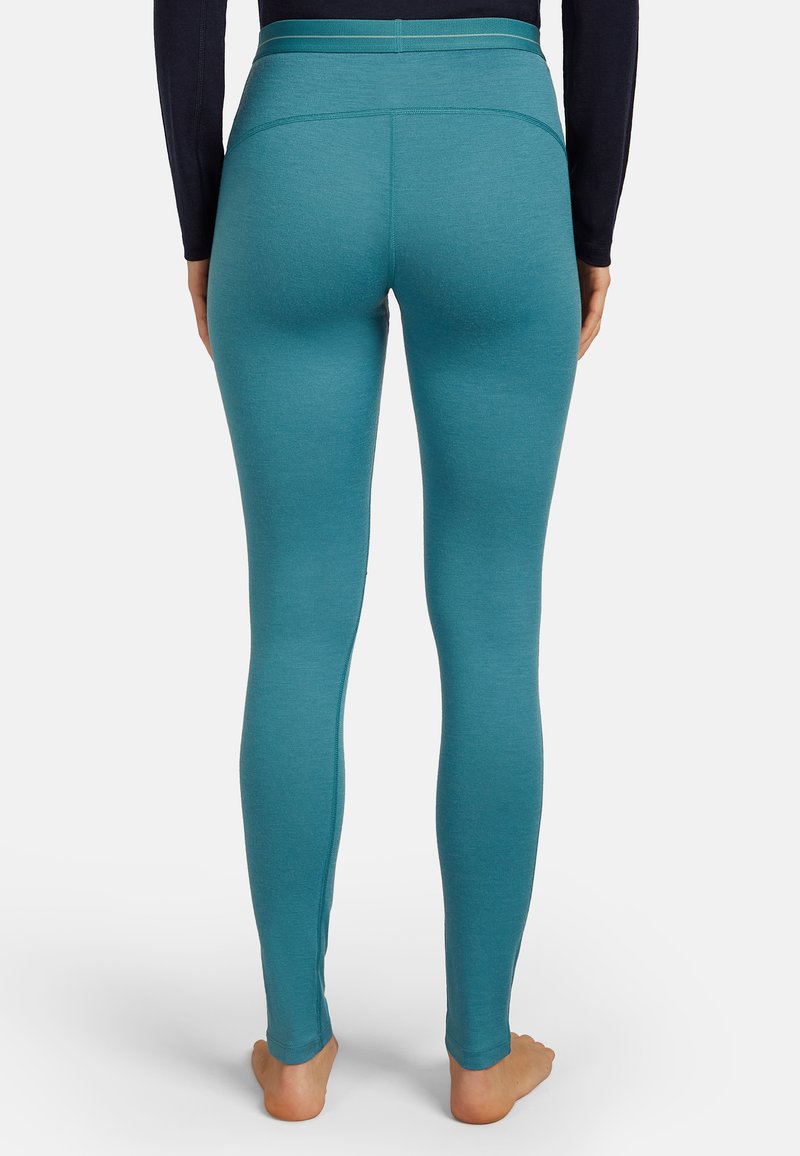 Tealfärgade leggings gjorda av ett mjukt, elastiskt tyg med hög midja och sömlös design, med en åtsittande silhuett.