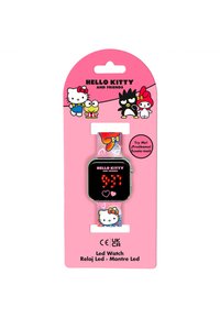 Orologio LED con cinturino trasparente caratterizzato da grafiche colorate di Hello Kitty, quadrante rettangolare nero che mostra l'ora in cifre rosse, confezione di cartone rosa.