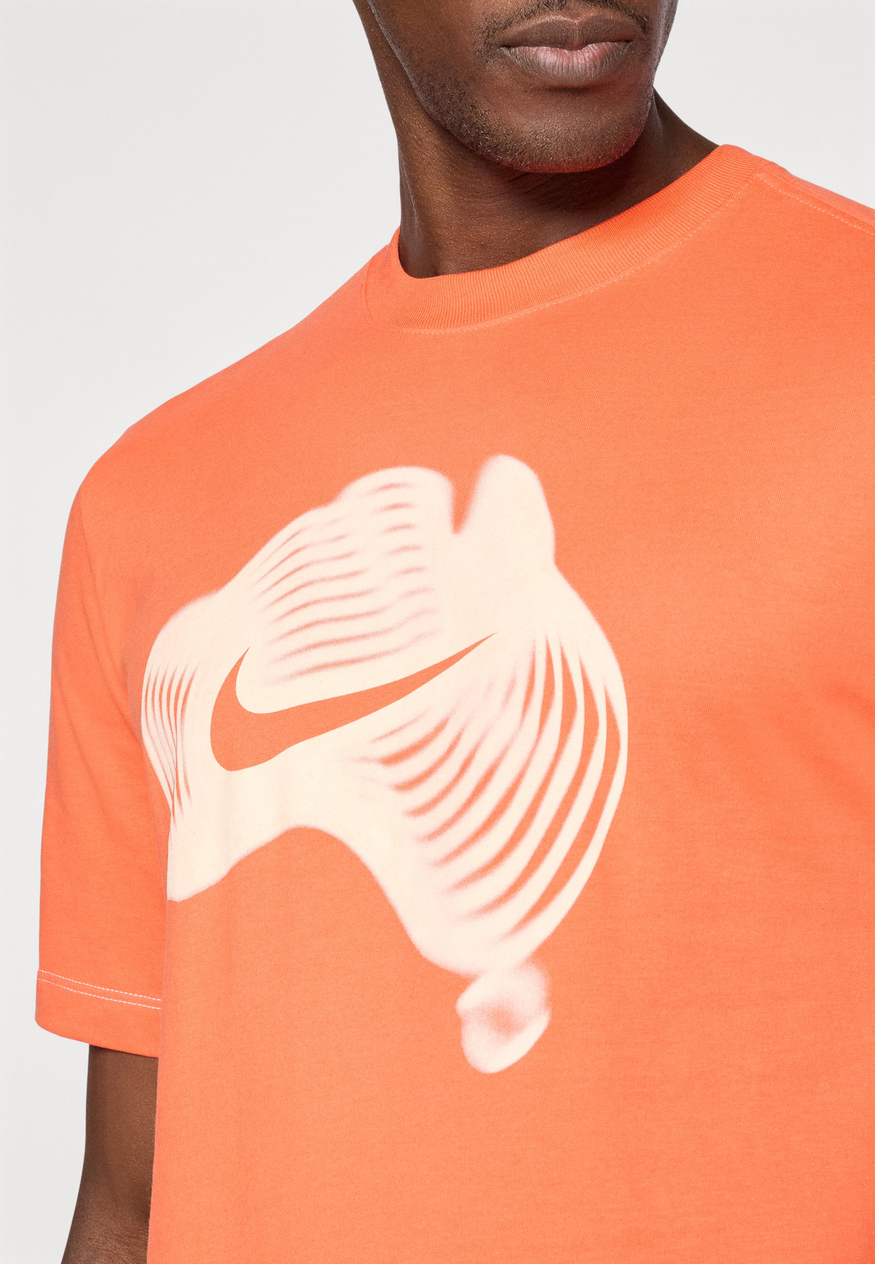 white nike shirt with orange