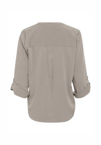 Light gray blouse with rolled sleeves, featuring a back yoke and a central pleat. Smooth fabric offers a soft texture.