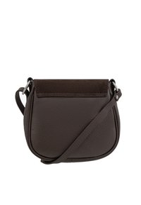 Brown leather crossbody bag with a textured surface, curved shape, suede accents on the flap, and a thin adjustable strap.